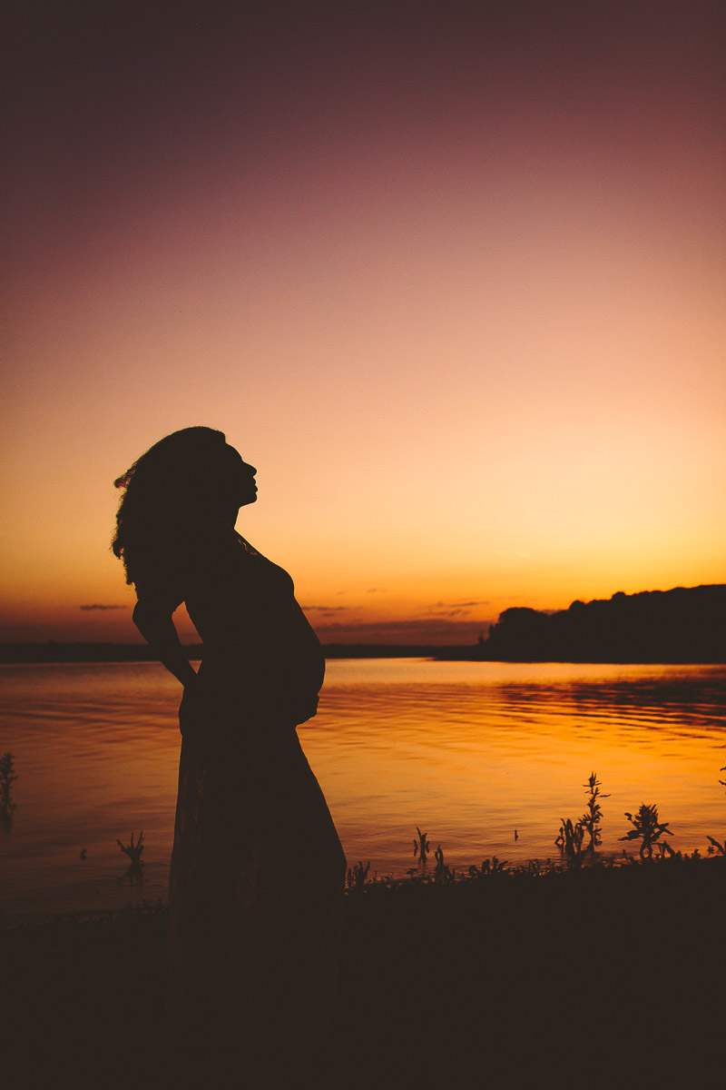 silhouette maternity photograph of a woman at saylorville lake iowa